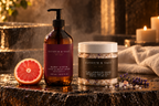 Ruby Vista Hand & Body Wash and The Languid Soak Mineral Bath Salt with a cut pink grapefruit in a candlelit bathroom setting.